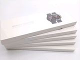 three white boxes with a watch on them are stacked on top of each other