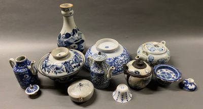 de nombreux vases bleus et blancs ainsi que d'autres objets posés sur la table