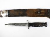 two knives are laying next to each other on a white surface