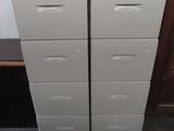 two drawers with baskets on top of them in a room
