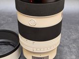 a camera lens sitting next to a cup on a table
