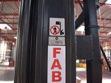 a sign on the side of a fork lift in a warehouse