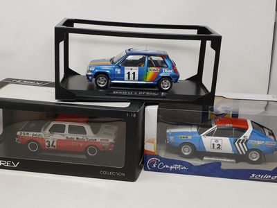three model cars in a display case on a table