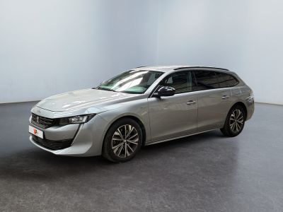 the silver car is parked in a white room with a black floor