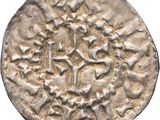 a silver coin with an image of a horse and rider on it