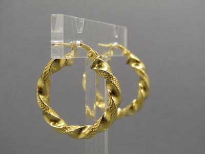 gold plated hoop earrings on display in a display case