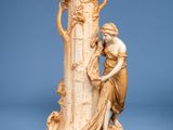 a statue of a woman holding a vase on a table