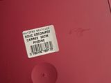 a label on the back of a red laptop