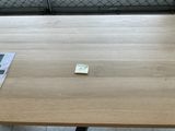 a small piece of paper on the table next to a laptop
