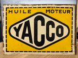 an old yellow and black sign with the word yacco on it
