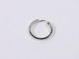 a close up of a silver ring on a white surface