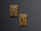 a pair of gold and emerald earrings