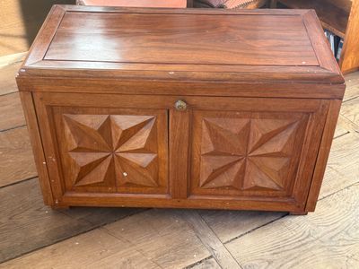 a wooden chest sitting on the floor in a room
