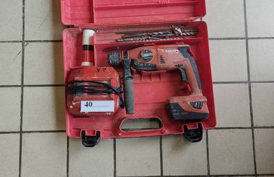 a red tool box with tools in it on a tiled floor