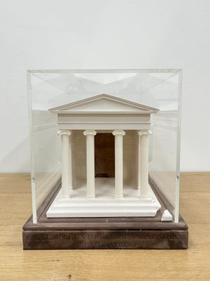 a small model of a building inside of a glass case