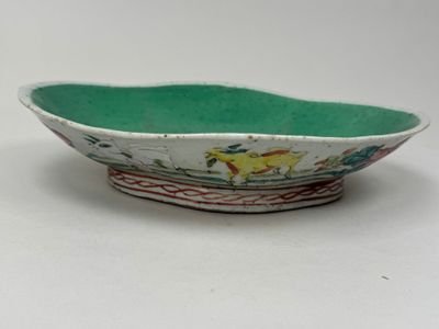 a small bowl with a design on it on a white surface