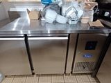 a stainless steel counter in a kitchen with a microwave