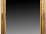 an antique gold framed mirror with a black background