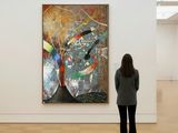 a woman standing in front of a painting in a museum