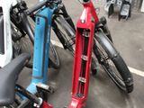 many bikes that are parked in a parking lot
