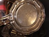 a silver plate with a mirror in it on a table