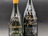 two bottles of wine are sitting next to each other on a table