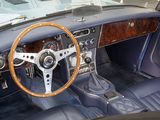 a steering wheel and dashboard of a classic car