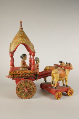 figurine représentant une calèche tirée par des chevaux, avec un homme à bord
