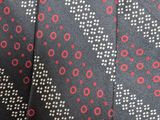 black and red tie with white dots and a black label on it