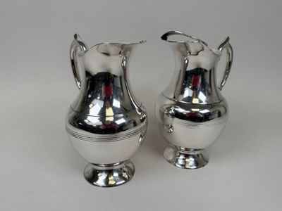 pair of silver plated vases on a white background