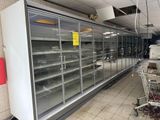 a grocery cart in front of a refrigerated freezer