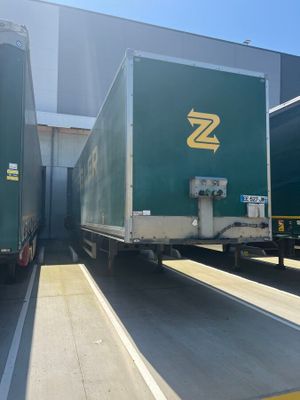 two trucks that are parked next to each other in a parking lot