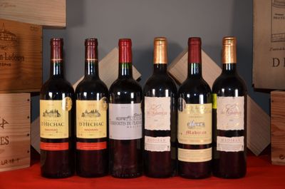 several bottles of wine are lined up on a red table