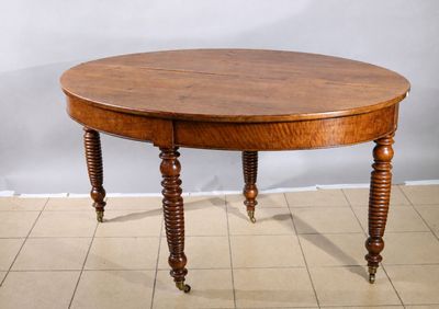 a wooden table with two legs and a round top