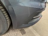 a close up of a car ' s front bumper and tire