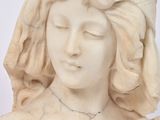 a statue of a woman with a rose in her hair