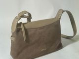 the small brown bag is sitting on a white surface