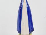 a blue and white vase with a yellow top on a table