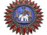 une image représentant un médaillon rouge et bleu sur lequel figure un homme chevauchant un éléphant