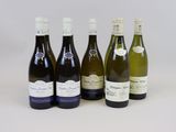six bottles of wine are lined up on a white surface