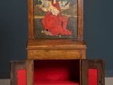 an old wooden cabinet with a painting on the top of it