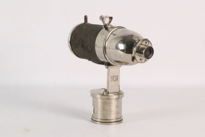 a small silver object on a white surface