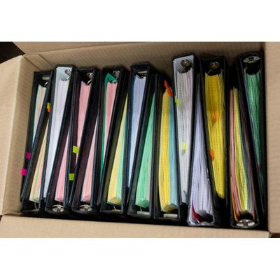a lot of folders in a box on the table
