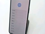 a cell phone that is sitting on a stand on a table