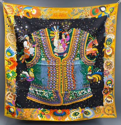 a black and yellow scarf with a colorful design on it