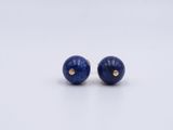 a pair of lapis stone stud earrings on a white background