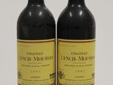 two bottles of wine sitting next to each other on a white surface