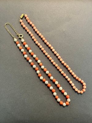 an orange and white beaded necklace with a gold clasp