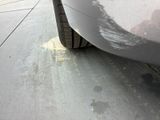a close up of a car ' s tire on the side of the road