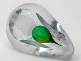 a glass object with a green leaf inside of it
